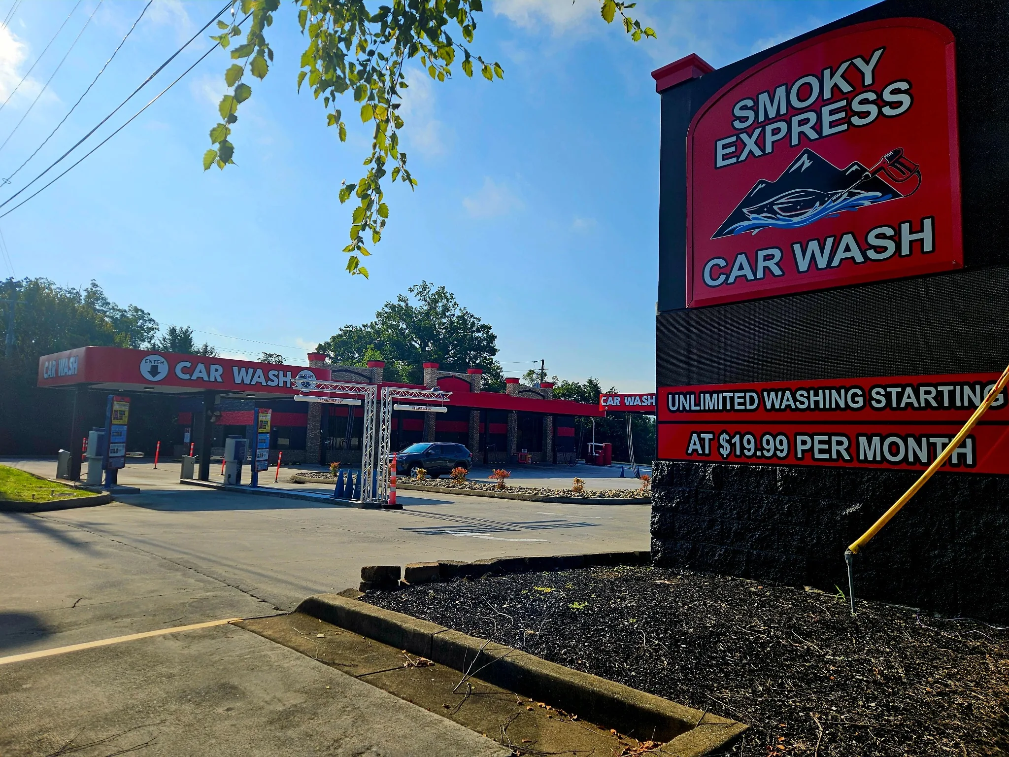 Smoky Express Sevierville roadside sign with the wash entrance in the background.