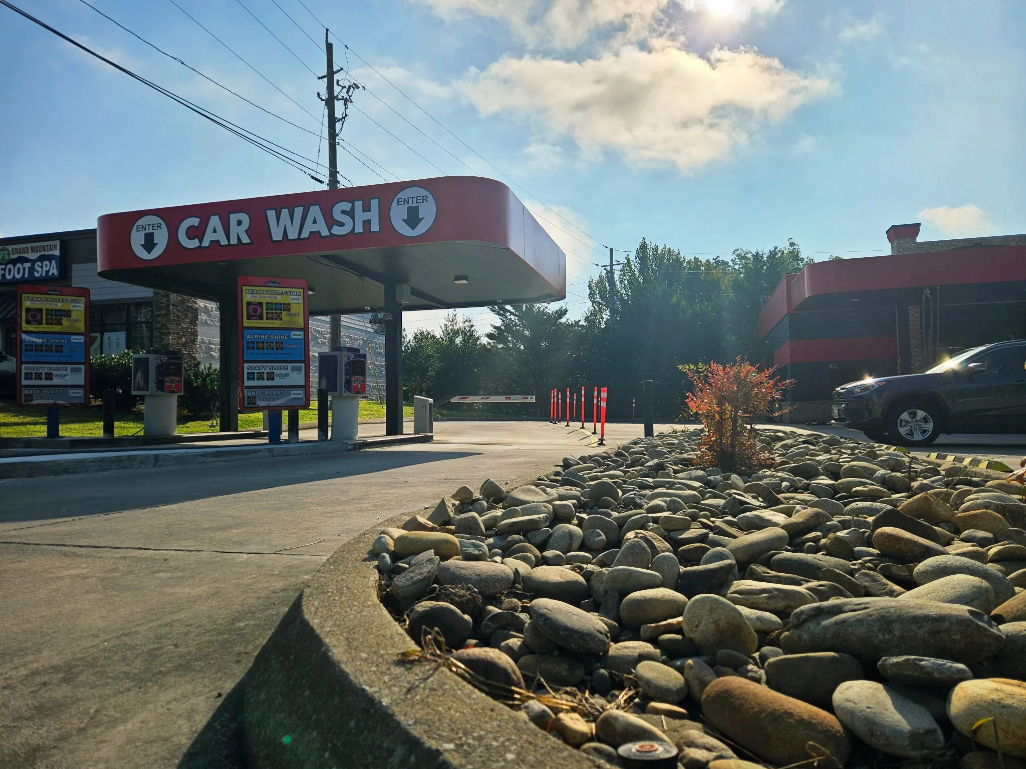 Sevierville car wash pay stations and entrance canopy on a sunny day.